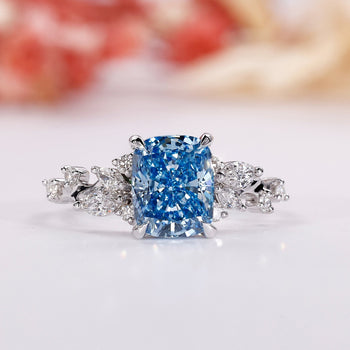 Blue diamond engagement ring with an elegant elongated cushion ring design.