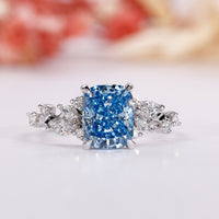 Blue diamond engagement ring with an elegant elongated cushion ring design.