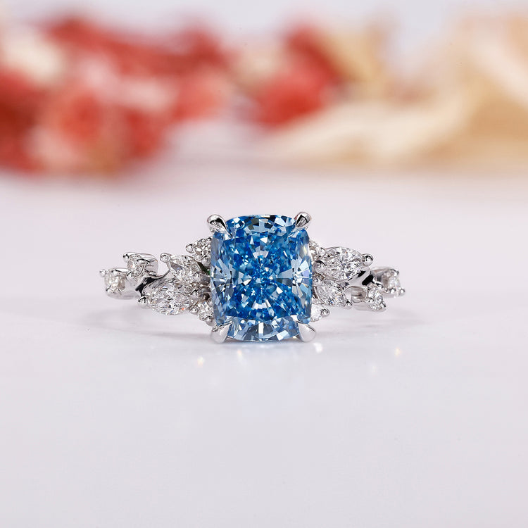 Blue diamond engagement ring with an elegant elongated cushion ring design.