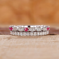 Ruby and diamond wedding band with round diamonds set in white gold.