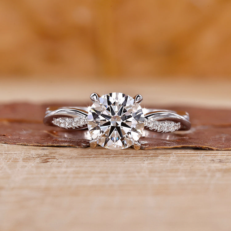 A sparkling round cut diamond ring placed on a velvet box.