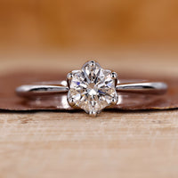 Round cut diamond ring with a sleek and elegant design.