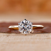 Round cut engagement ring with a brilliant center stone.