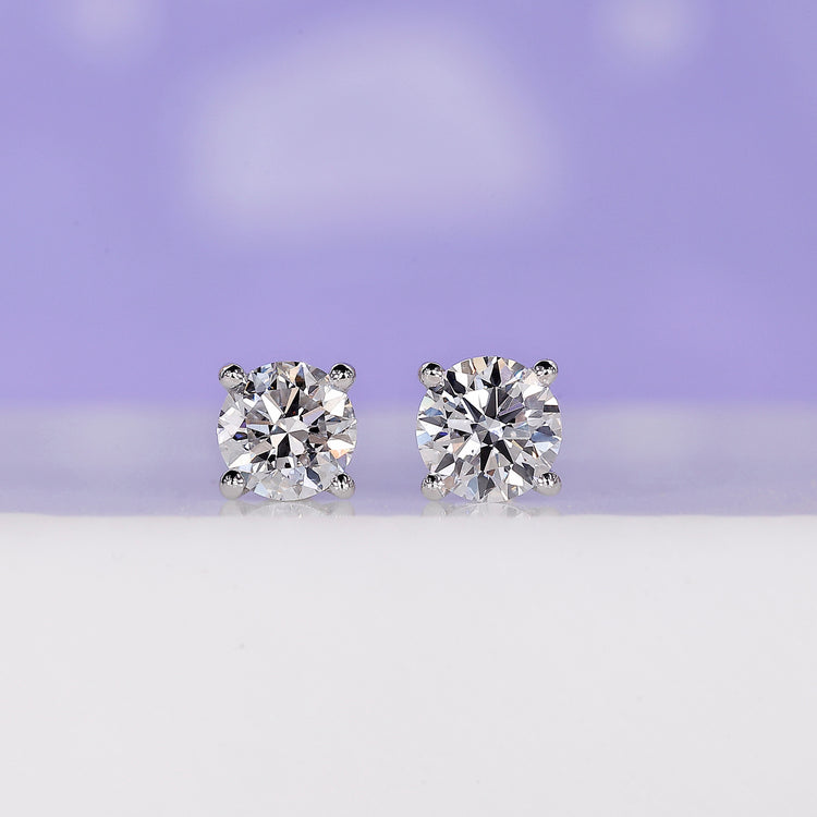 Elegant round stud earrings 0.70 TCW with classic design.