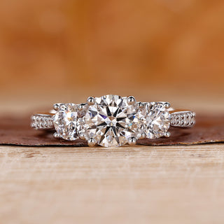 3 Stone Engagement Ring featuring a classic round diamond.