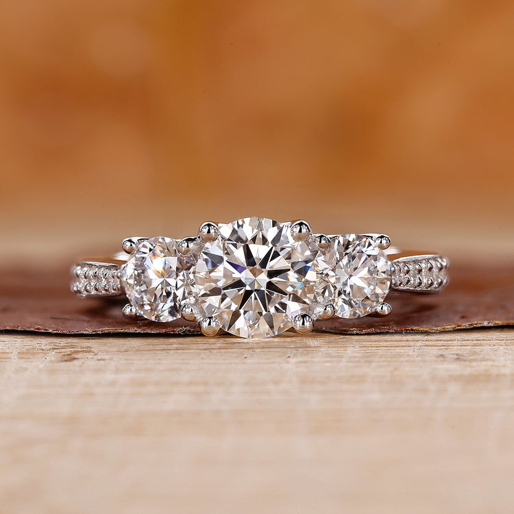 3 Stone Engagement Ring featuring a classic round diamond.