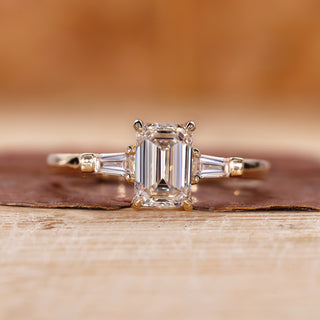 3 Stone Emerald Cut Diamond Ring with tapered baguette accents.