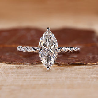 Marquise diamond ring set in a compass prong setting, offering a unique and secure hold.