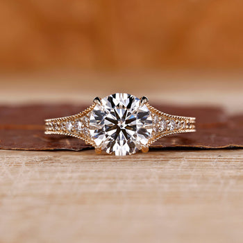 Round cut diamond ring with tapered pave setting.
