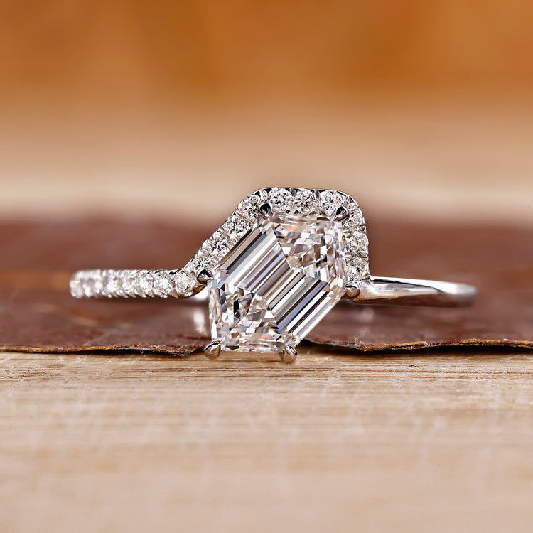 Hexagon diamond ring with round cut side stones in white gold.