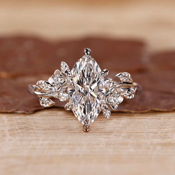 Marquise engagement ring with a sleek design and round side stones for added detail.
