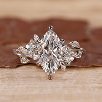Marquise engagement ring with a sleek design and round side stones for added detail.