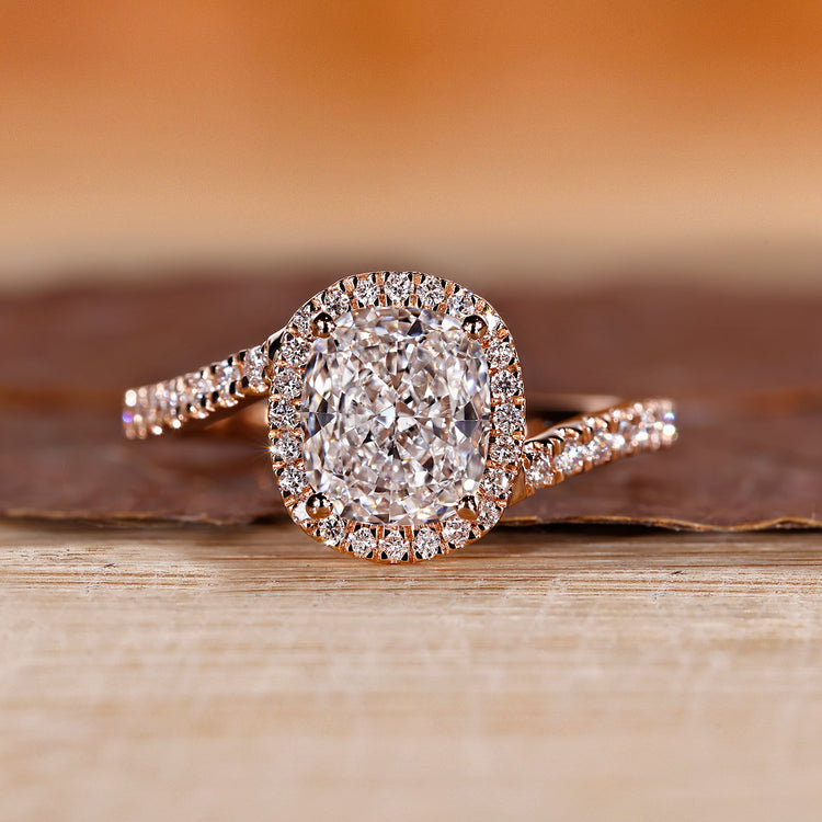 Cushion halo engagement ring in rose gold.