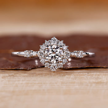 Round cut diamond engagement ring with a halo engagement ring design.