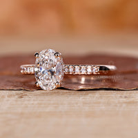 Side view of an oval cut lab grown diamond engagement ring, featuring the hidden halo and intricate prong details.