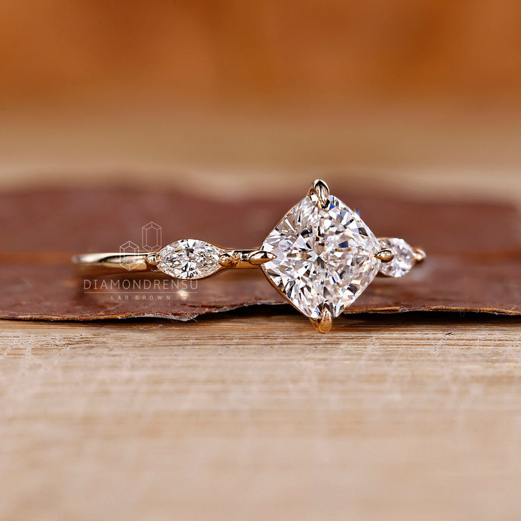 Cushion and marquise diamond ring in yellow gold.