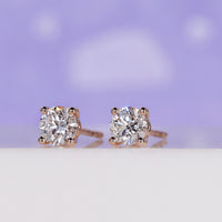Sparkling round diamond earrings studs in a rose gold finish.