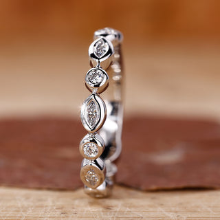 Round and marquise wedding band with a sleek finish.