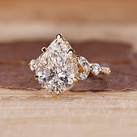 Round cut hidden halo ring with pear diamond and knife edge shank.