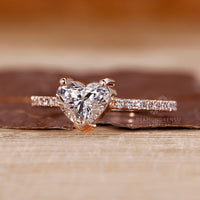 Two round prong ring with heart shaped diamond in rose gold.