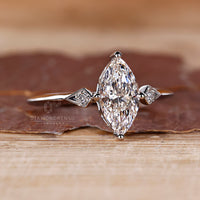 White gold engagement ring featuring marquise and round diamond design.