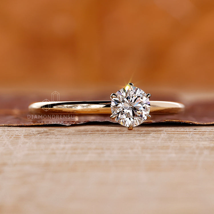 Round brilliant cut solitaire diamond ring set in custom yellow gold.