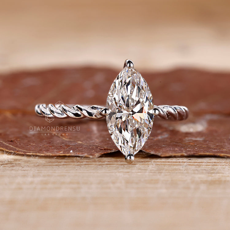 Twisted pave band engagement ring with a diamond center, offering a distinctive and detailed design.