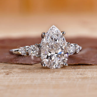 Buy engagement ring with pear and round diamonds.