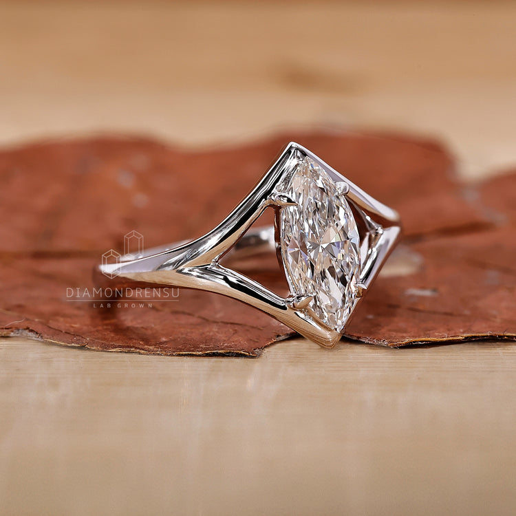 Solitaire Ring with a brilliant marquise diamond at the center.
