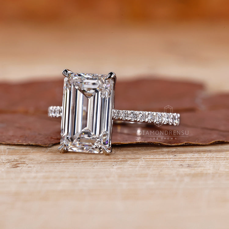 White Gold Ring with a classic emerald cut diamond centerpiece.