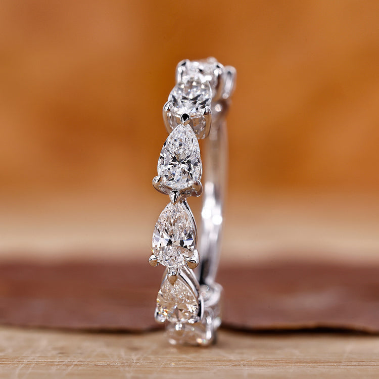 A pear-shaped wedding band with sparkling lab-grown diamonds.