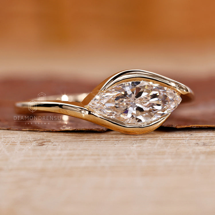 East west marquise ring with a stunning half bezel setting for added security