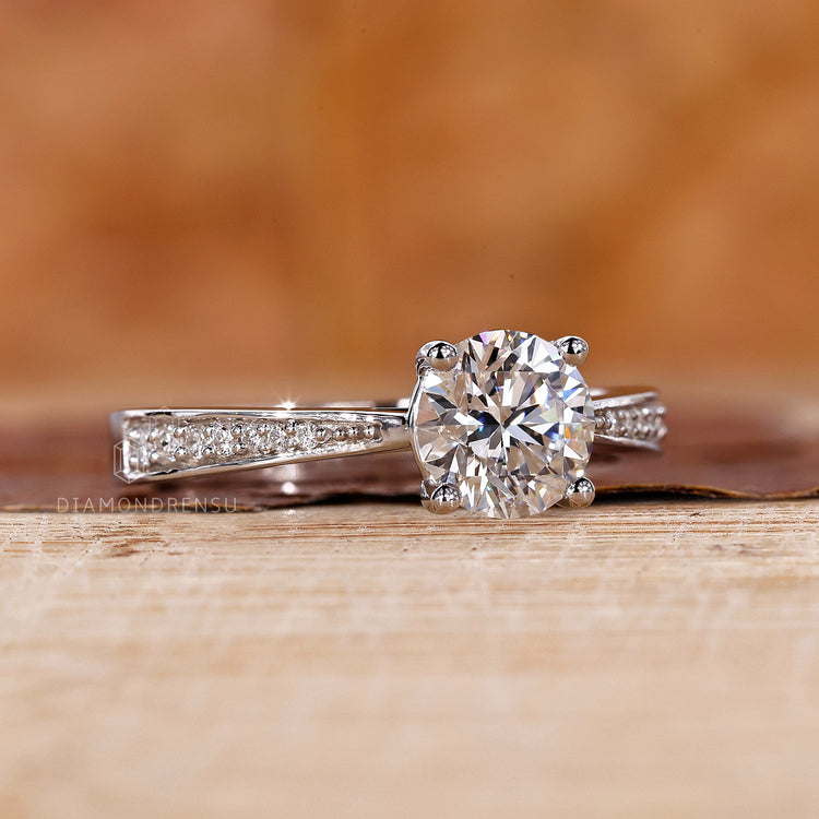 Tapered Pave Engagement Ring featuring a brilliant round diamond.
