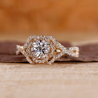 Lab-grown diamond halo engagement ring with twisted pave setting.