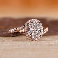 Halo engagement ring with prong setting.