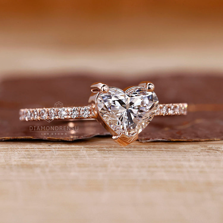 Rose gold ring with heart shaped diamond and v shaped prong.