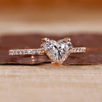 Rose gold ring with heart shaped diamond and v shaped prong.