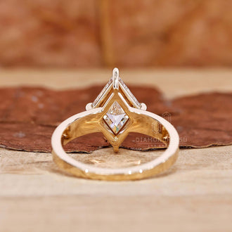A side profile shot of a gold engagement ring adorned with a captivating lozenge cut diamond, symbolizing eternal love and commitment.