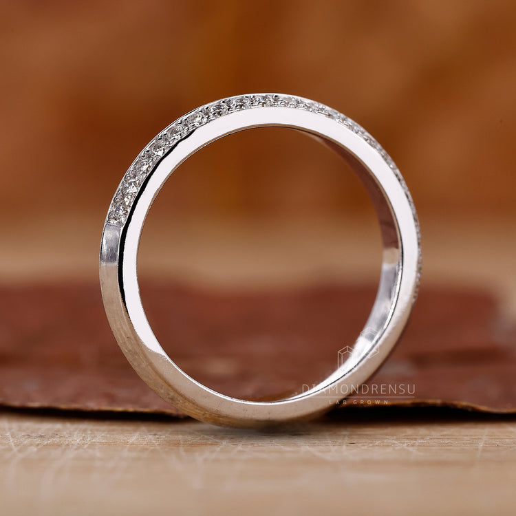 Custom diamond band with one side pave knife edge.