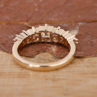 Buy wedding band with French cut diamonds set in yellow gold.