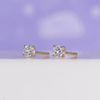 Diamond earrings for women in stunning yellow gold and elegant prong setting.