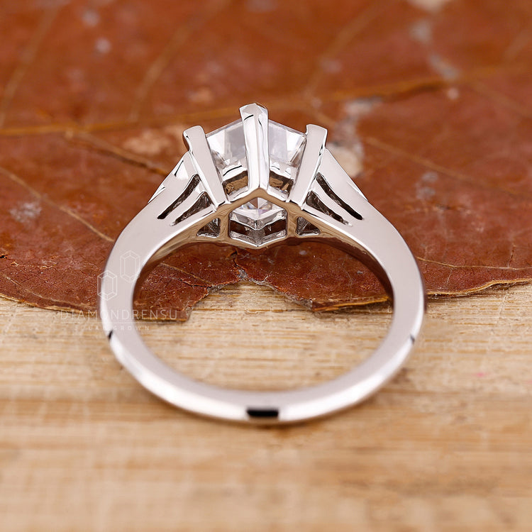 Custom diamond ring with hexagon center stone and side accents.
