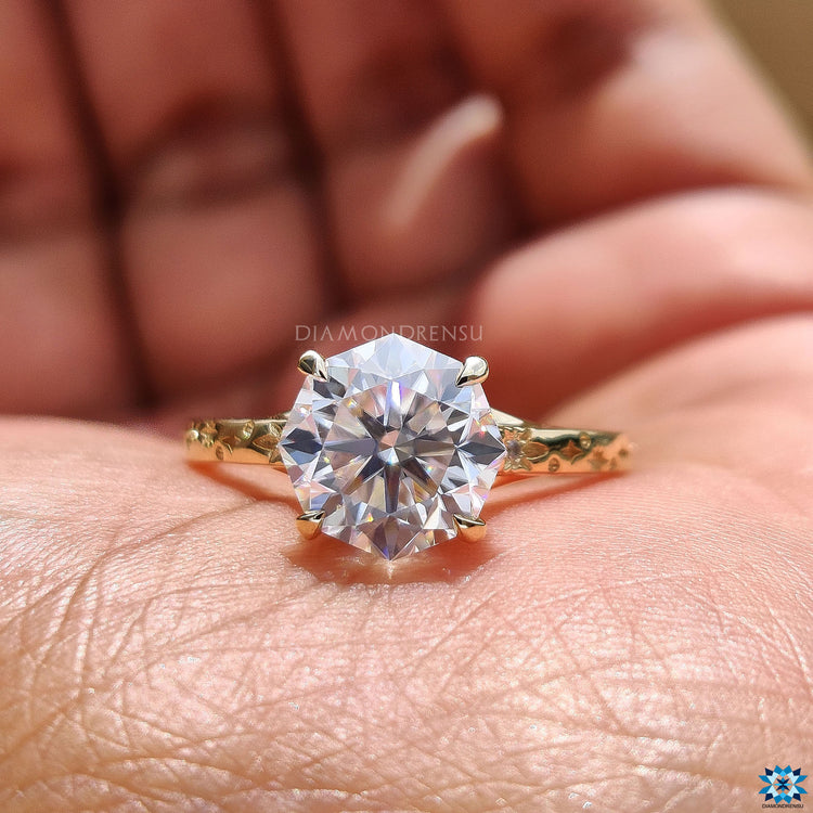 Round cut side stone adds extra brilliance to the design.