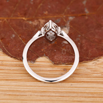 IGI certified marquise and round diamond engagement ring in white gold.