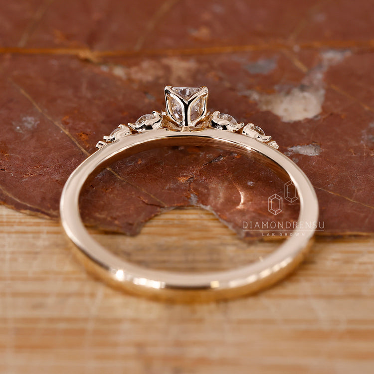 Handmade ring with shared prong setting and radiant cut center stone.