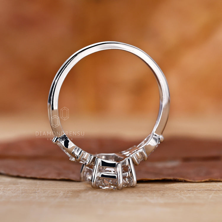 Hexagon cut diamond engagement ring with side stones.