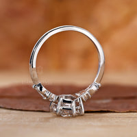 Hexagon cut diamond engagement ring with side stones.