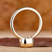 Yellow gold ring engagement with a bezel set cushion diamond for a modern touch.