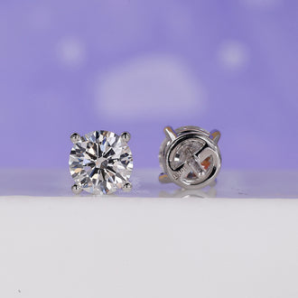 Stud women's earrings in white gold featuring a push in earrings mechanism.