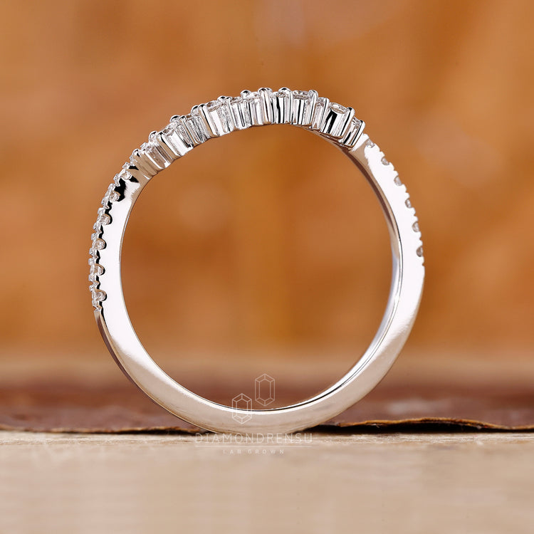 Handmade jewelry featuring a curved diamond band